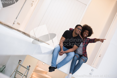 Image of couple having break during moving to new house