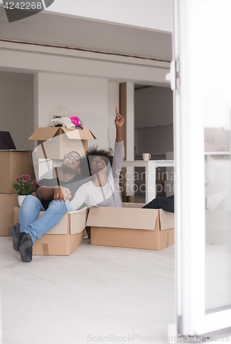 Image of African American couple  playing with packing material