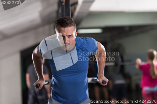 Image of man doing exercises parallel bars