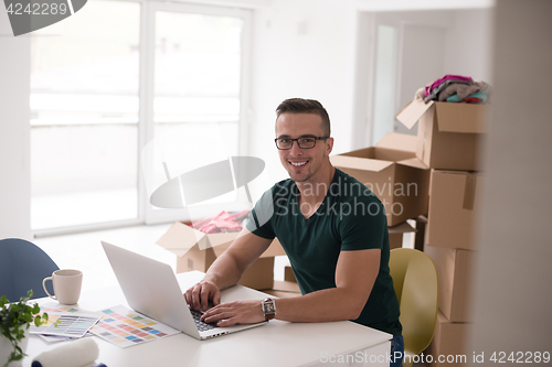 Image of Young man moving in a new home