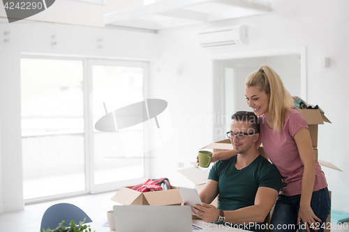 Image of Young couple moving in a new home