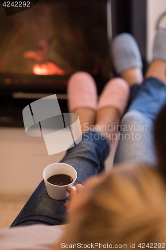 Image of Young couple  in front of fireplace