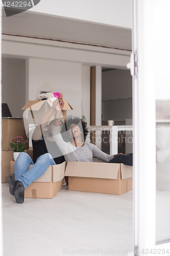 Image of African American couple  playing with packing material