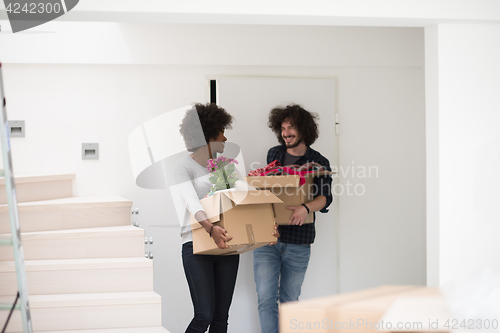 Image of multiethnic couple moving into a new home