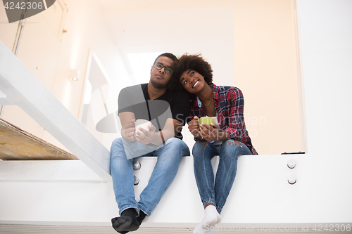 Image of couple having break during moving to new house