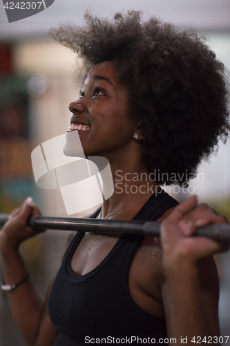 Image of black woman lifting empty bar