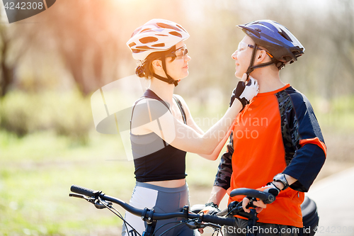 Image of Two friends wear bike helmets