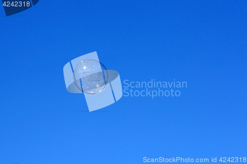 Image of Soap bubble flying against the blue sky
