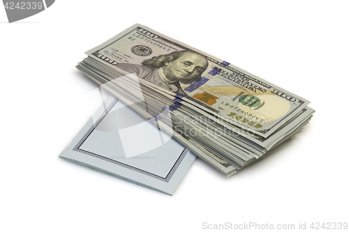 Image of One hundred dollars banknotes lie on checkbook isolated on white