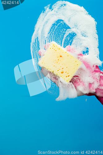 Image of Cleaning glass window with sponge