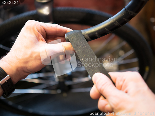 Image of Guy winds tape on bike