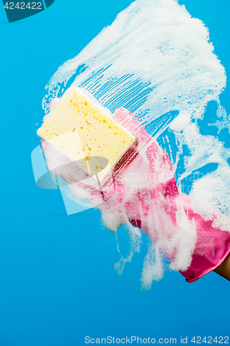 Image of Washing window with soap and sponge