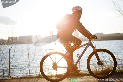Image of Woman in helmet on bicycle