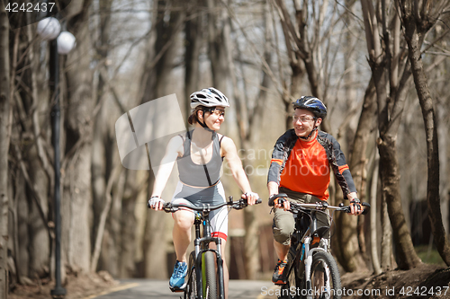 Image of Two bicyclists drive around park