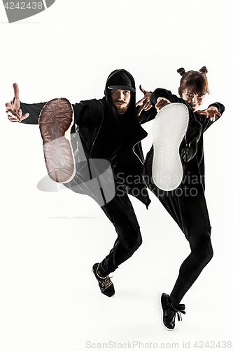 Image of The silhouettes of two hip hop male and female break dancers dancing on white background