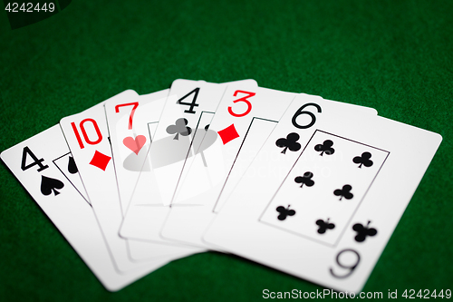 Image of poker hand of playing cards on green casino cloth