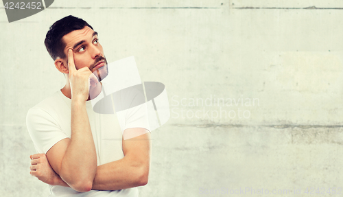 Image of man thinking over gray background