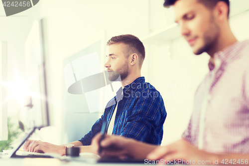 Image of creative man or student with computer at office