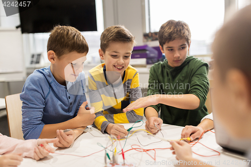 Image of happy kids with invention kit at robotics school