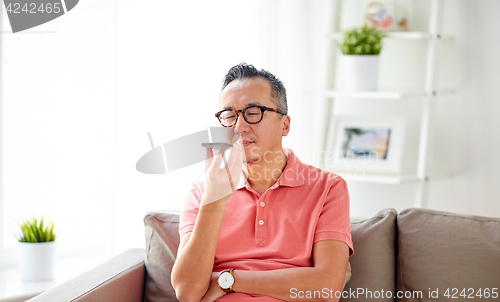 Image of man using voice command recorder on smartphone