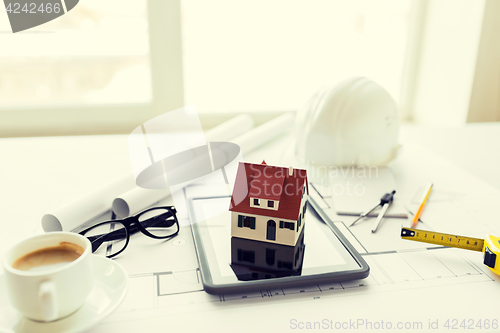 Image of close up of living house model on tablet pc