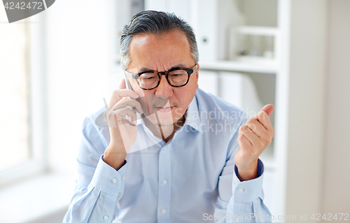 Image of businessman calling on smartphone