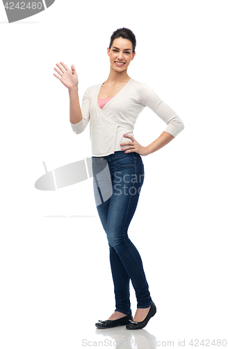 Image of happy smiling young woman waving hand over white