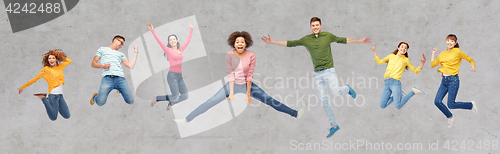 Image of happy people or friends jumping in air over gray