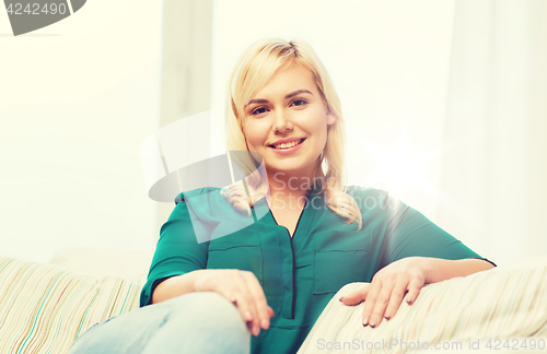 Image of happy young woman at home
