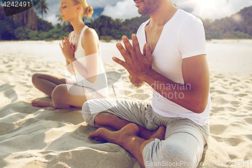 Image of close up of couple making yoga exercises outdoors