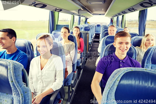 Image of group of happy passengers in travel bus