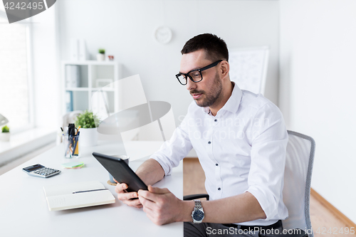 Image of businessman with tablet pc at office