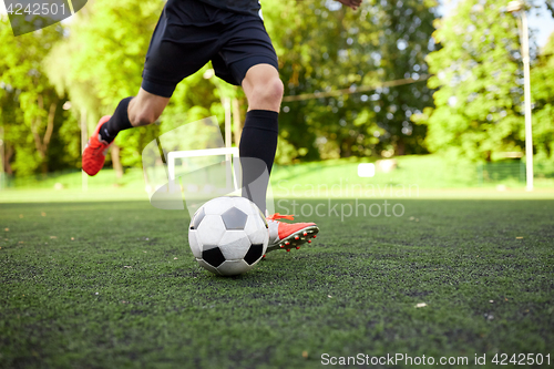 Image of soccer player playing with ball on field