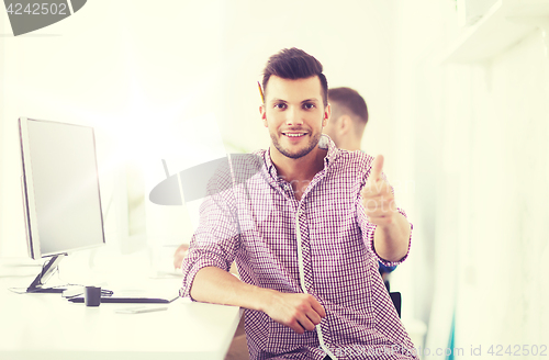 Image of happy creative man with computer at office