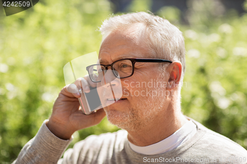 Image of happy senior man calling on smartphone in city