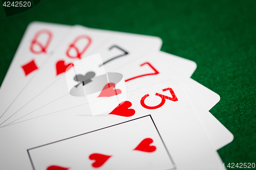 Image of poker hand of playing cards on green casino cloth