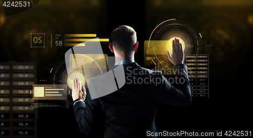 Image of businessman touching virtual screen