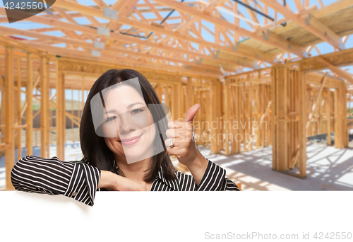 Image of Hispanic Woman With Thumbs Up On Site Inside New Home Constructi