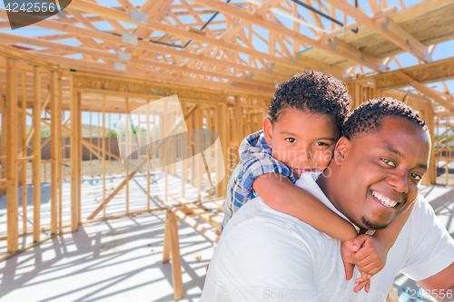 Image of Young African American Father and Mixed Race Son On Site Inside 