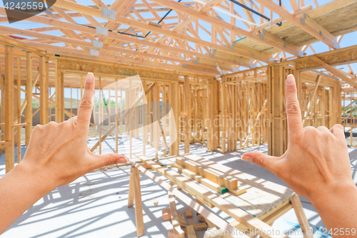 Image of Hands Framing Inside New Home Construction Framing.