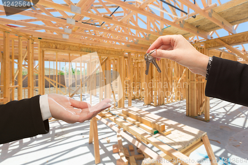 Image of Handing Over The Keys On Site Inside New Home Construction Frami