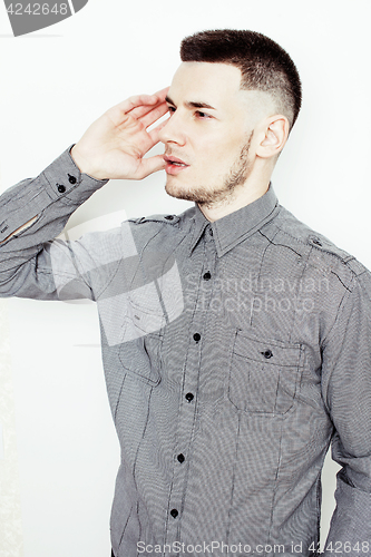 Image of young handsome well-groomed guy posing emotional on white background, lifestyle people concept 