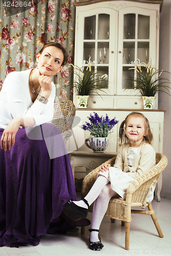 Image of young mother with daughter at luxury home interior vintage