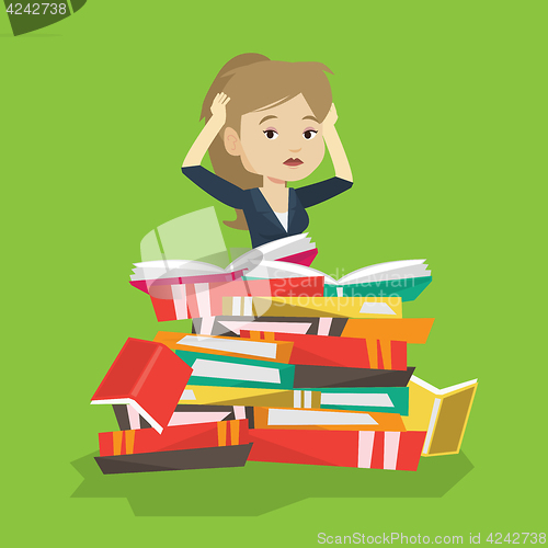 Image of Student sitting in huge pile of books.