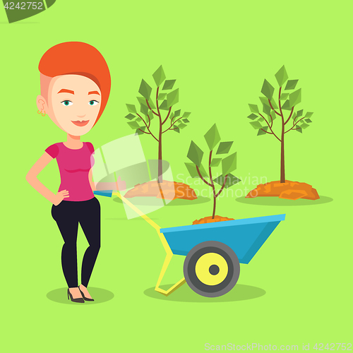 Image of Woman pushing wheelbarrow with plant.