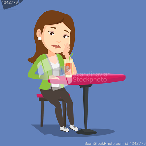 Image of Woman drinking cocktail at the bar.