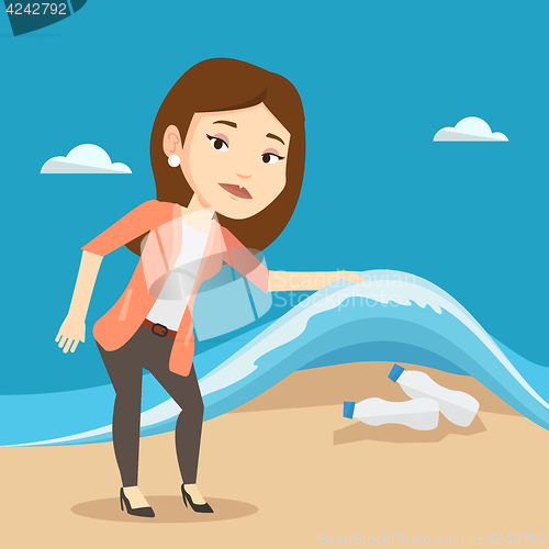 Image of Woman showing plastic bottles under sea wave.