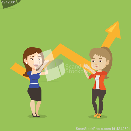 Image of Two business women holding growth graph.