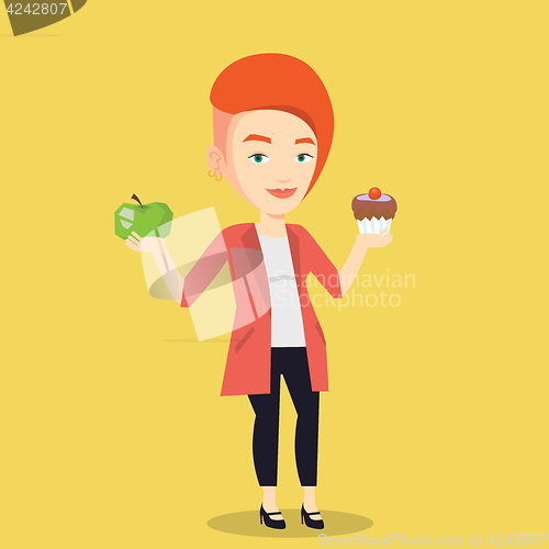 Image of Woman choosing between apple and cupcake.