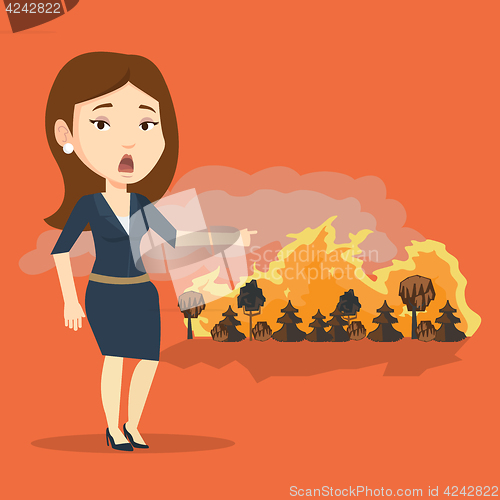 Image of Woman standing on background of wildfire.